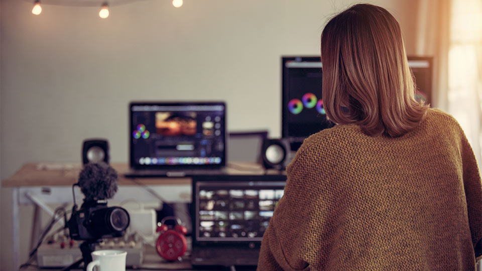 woman editing video from home