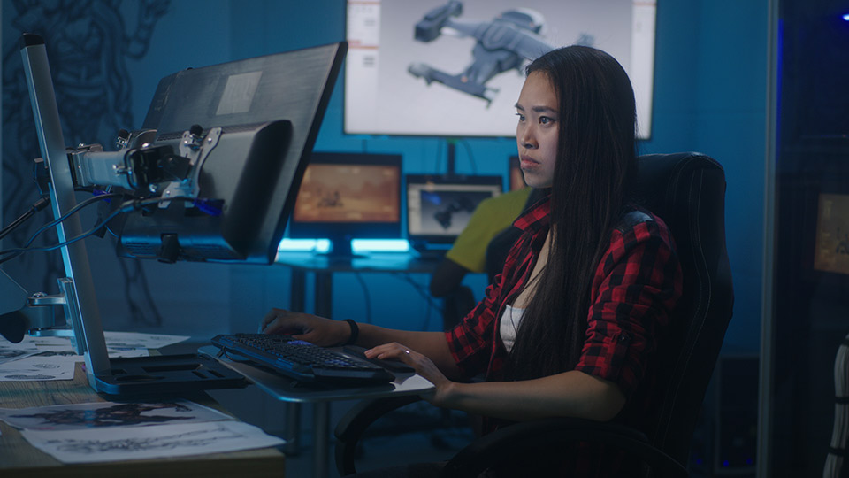 3D artist working at a desk.