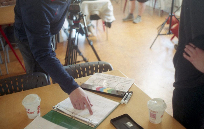 People reviewing a binder with notes