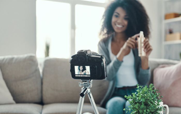 behind the scenes of a content creator shooting a video of herself with a product