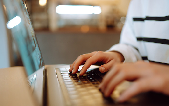 Hands on laptop, working from home